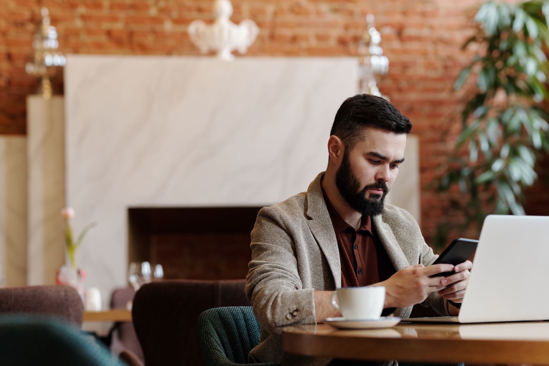 Business owner managing click-to-chat lead generation conversations on a laptop and smartphone
